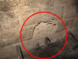 One or more refractory panels (the 1-inch thick fireproof panels lining the fireplace wall) were significantly damaged.