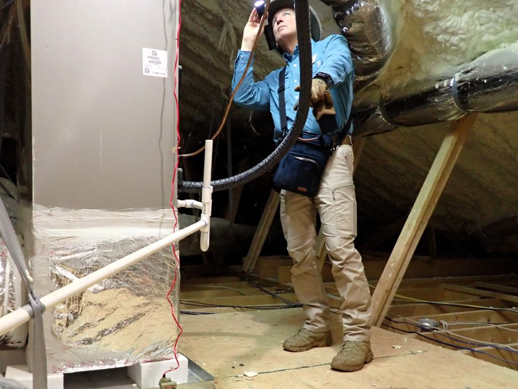 ASHI Certified home inspector inspecting attic HVAC system in North Metro Atlanta