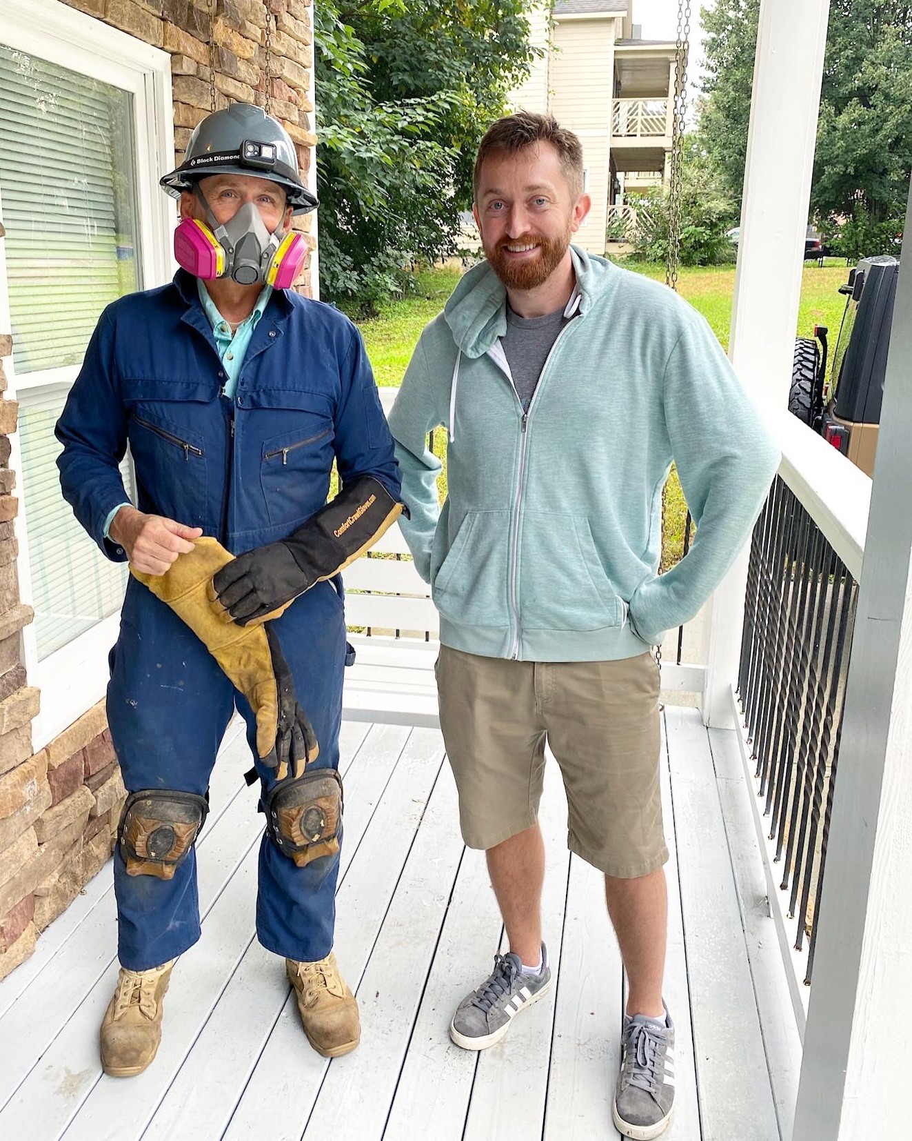 Certified home inspector in Johns Creek performing detailed crawlspace inspection with protective gear