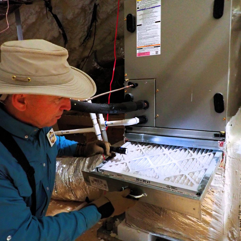 ASHI Certified home inspector inspecting attic HVAC system in North Metro Atlanta
