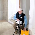 Home inspector setting up radon testing equipment in a North Metro Atlanta home